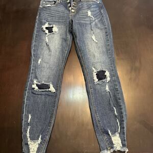 Distressed blue denim jeans